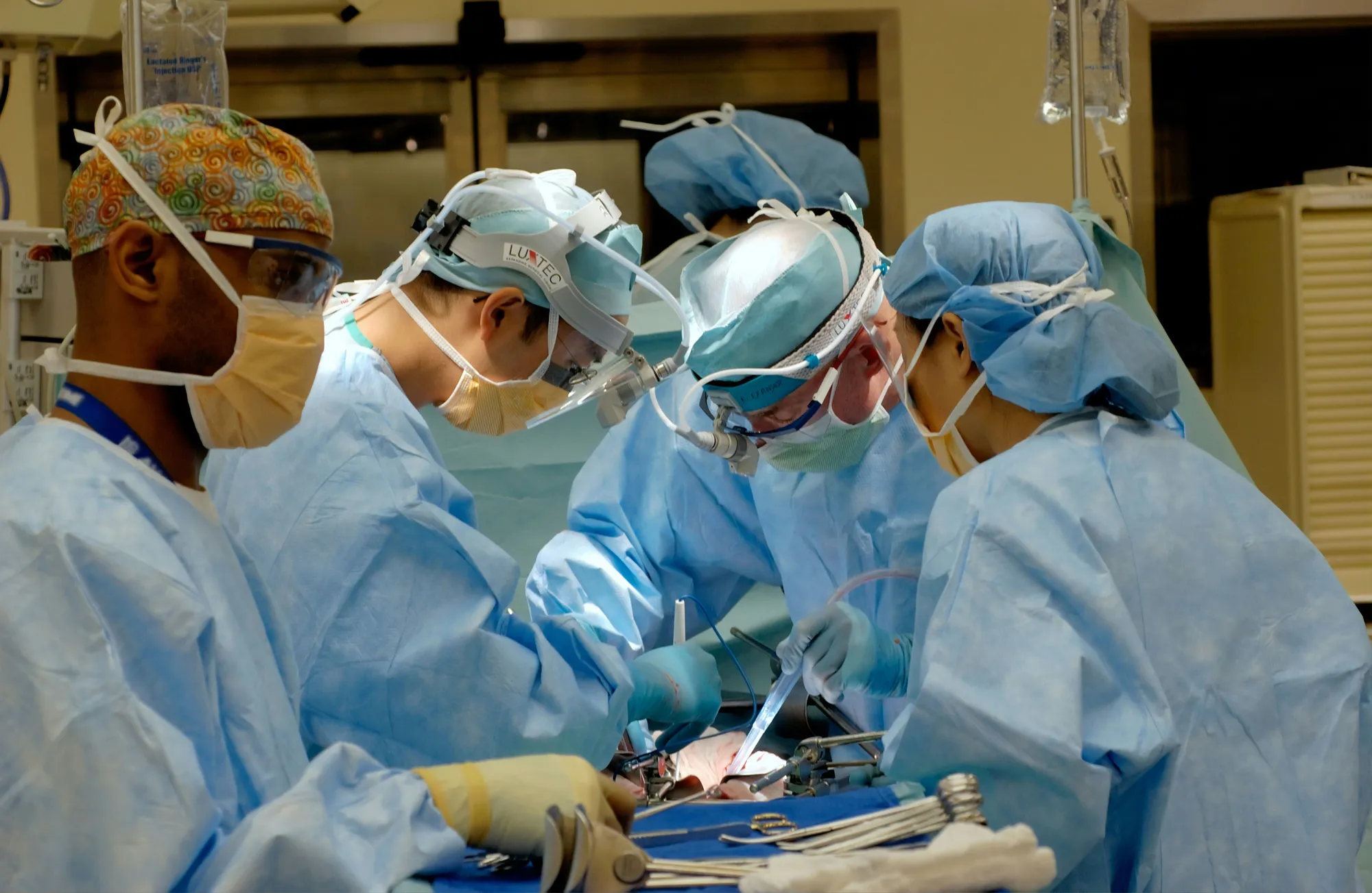 A clinical team working shoulder to shoulder around a patient